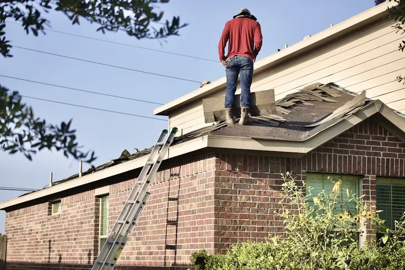 Professional roofer working on a residential roof in Crest Ridge Gardens